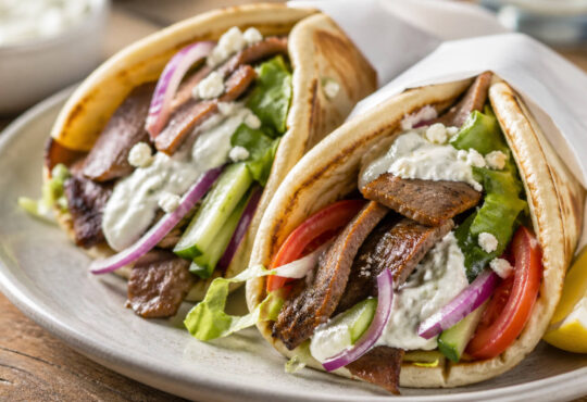 Easy beef gyro recipe with seasoned beef, warm pita, fresh vegetables, and tzatziki sauce