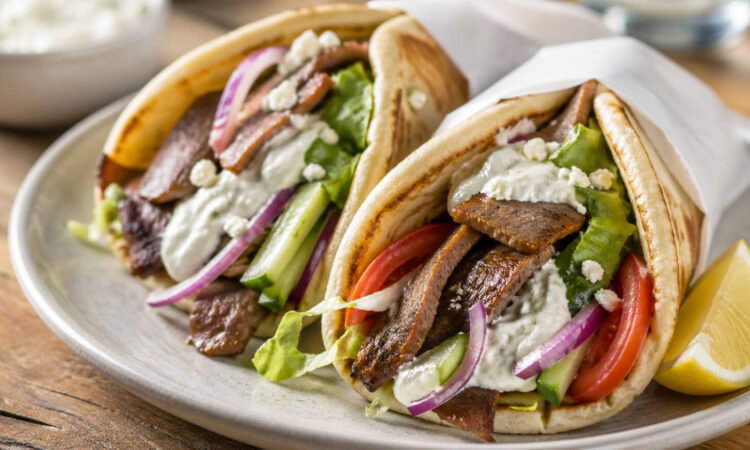 Easy beef gyro recipe with seasoned beef, warm pita, fresh vegetables, and tzatziki sauce