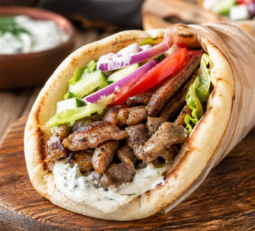 Easy pork gyro recipe with seasoned pork, warm pita, fresh vegetables, and tzatziki sauce