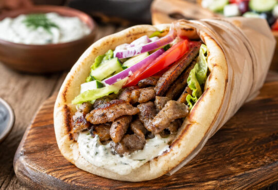 Easy pork gyro recipe with seasoned pork, warm pita, fresh vegetables, and tzatziki sauce