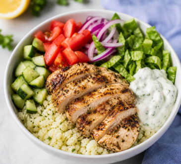 Easy low carb gyro bowl with keto gyro meat, cauliflower rice, cucumber, tomatoes, lettuce, and tzatziki sauce