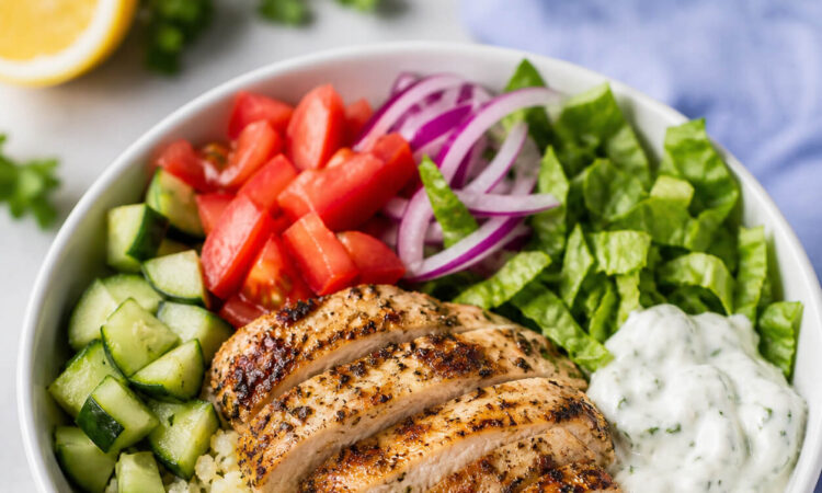 Easy low carb gyro bowl with keto gyro meat, cauliflower rice, cucumber, tomatoes, lettuce, and tzatziki sauce