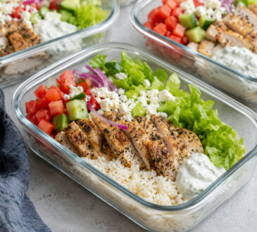 Chicken gyro meal prep bowls with Greek chicken, rice, cucumber, tomatoes, red onion, lettuce, and tzatziki sauce
