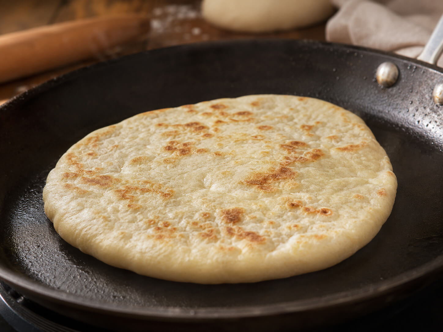 Soft pita bread for gyros filled with gyro meat, tomatoes, onions, lettuce, and tzatziki sauce